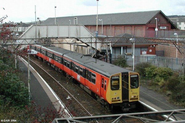 Neilston Railway Station
Opened in 1903 it was originally part of the Caledonian line from Glasgow to Ardrossan.  Neilston is now the end of the line and new housing has been built on the former path of the railway.  In the early 1960's the line was electrified for the 'blue trains'.  The old goods shed can be seen still standing in the background.
