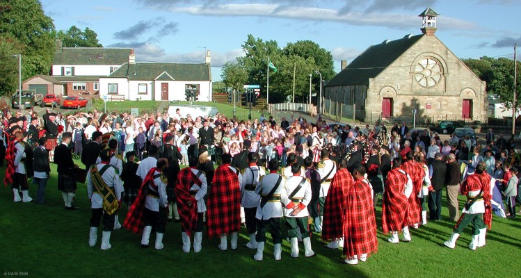 2006, Pipers at Pig Square
As if by magic the sun comes out as the Neilston & District Pipe Band takes centre stage at Pig Square.  
