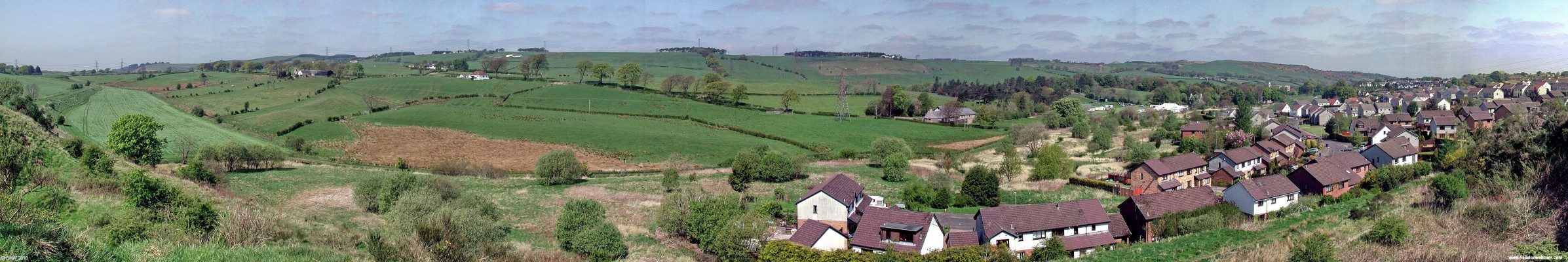 Over looking the east side of Neilston
On the extreme left you can see the old railway embankment from the days when the Neilston line carried on to the coast.  The Lochliboside and Fereneze hills are all along the horizon.  In the fields in front of the houses you'll see preparations being made for the 2007 Neilston Show.  [url=http://www.streetmap.co.uk/map.srf?X=246782&Y=656325&A=Y&Z=115/] Map location. [/url]
