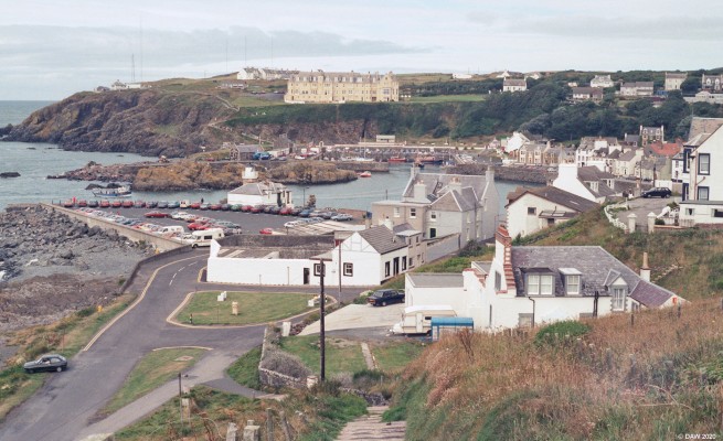 Portpatrick, 1989
A view over the harbour area at Portpatrick.  On the top left on the cliff can be seen what was Portpatrick maritime radio station which operated from the 1930's up until 2000.  Most of the aerials you see are now gone. [url=http://streetmap.co.uk/map.srf?X=199980&Y=553885&A=Y&Z=115/] Map location. [/url]
