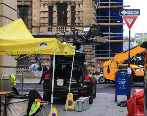Pursuit Camera Car, World War Z, Glasgow
[url=http://www.advancedcameracars.com/] Pursuit [/url] is a specialised camera car with a steerable arm with the camera on the end.  You can see the camera covered in polythene hanging from the arm to the left of the car.  Notice the blue US mail box on the right, I thought they were rubbish bins when I visited Philadelphia many years ago.
