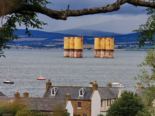 Hull of Hutton TLP Oil Rig, Cromarty
The rather unattractive view from Cromarty in 2009.  The hull of the Conoco Hutton TLP Oil Rig lies out in the firth awaiting disposal.  It was the first Tension Leg Platfrom and was built across the firth at Nigg Construction yard in the 1980's.  The Deck was also built nearby at Ardersier but it has already been removed at Murmansk in Russia. [url=http://www.streetmap.co.uk/map.srf?X=278798&Y=867315&A=Y&Z=115/] Map location. [/url]
