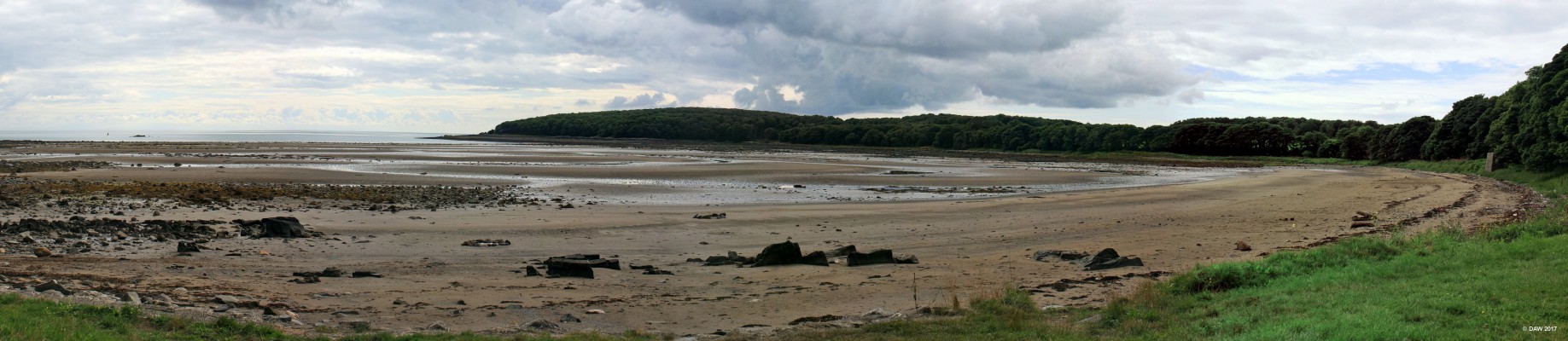 Rigg Bay, Garlieston
This seemingly deserted bay played a vital role between 1943 and 1944 in the testing of parts of the Mullbery Harbour used after the D-Day landings in Normandy during World War II.  The bay was picked because it was remote and the beach had similar characteristics to that of the Normandy landing site.  At low tide you can see the remains of one of the fixed pierheads which was destroyed in a storm in 2006, it can be seen on the left of the photo not far off the shore.

