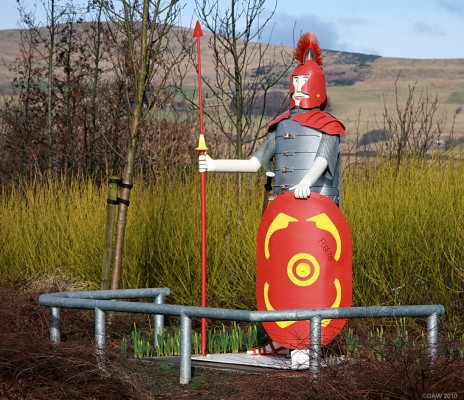 Roman Centurian, Dullatur
Made by a local retired farmer, John Colquhoun.  He donated it to Cumbernauld on the 50th anniversary of the new town in 2007.  It now stands guard on one of the roads into the small village of Dullatur.  Dullatur is close to the line of the Antonine wall and there was also a Roman fort nearby.  [url=http://www.streetmap.co.uk/map.srf?X=275110&Y=676880&A=Y&Z=120/] Map location. [/url]
