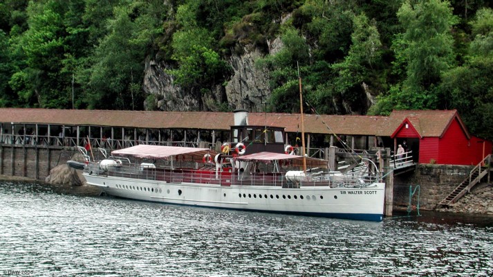 The SS Sir Walter Scott at the Trossachs Pier, Loch Katrine
Built at Denny's in Dumbarton in 1900, she had to be brought piece at a time by barge up Loch Lomond to Inversnaid and then across land on the steep single track road to Stronachlacher where she was re-assembled.  She displaces some 115 tons and still uses the original 3 cylinder triple expansion steam engine.  For more than 100 years she has been taking visitors on [url=http://www.incallander.co.uk/steam.htm]cruises [/url]around Loch Katrine. 
