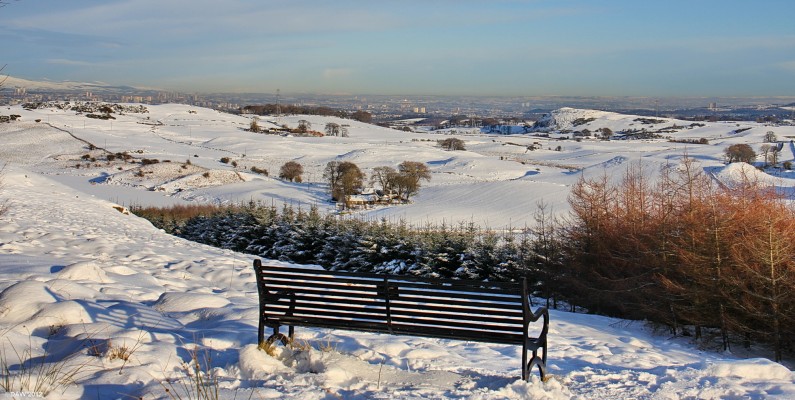 Seat with a view, Neilston Pad
Just a short climb up from the main circular track round the Neilston Pad gets the reward of this seat and view.  On the left you can see the frozen and snow covered Snypes Dam.  Towards the right is Duncarnock Hill more commonly known as The Craigie.  Glasgow is spread out all along the horizon. [url=http://www.streetmap.co.uk/map.srf?X=247495&Y=654870&A=Y&Z=120/] Map location. [/url]
