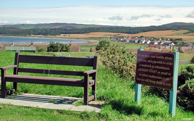 Seat with optional Sandwich, Maidens
The seat happens to be in the grounds of Malin Court Hotel and has a wonderfull view over Turnberry Golf course so I dare say some people won't want to give it up just to have lunch!  The small village of Maidens is in the background.  [url=www.multimap.com/map/browse.cgi?lat=55.3318&lon=-4.8264&scale=25000&icon=x/]Map location[/url]
