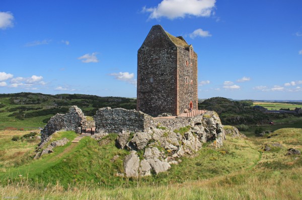 Smailholm Tower, Scottish Borders
A view of Smailholm Tower, near Kelso.  Dating from the 15th century it stands on a promintary of rock.  The remains of a ditch can be seen in this photgraph along with the ruins of the  "Barmkin" wall which had outbuildings and a chapel within it.   Today the Tower is under the care of Historic Environment Scotland and is open to the public in the summer.  [url=http://streetmap.co.uk/map.srf?X=363881&Y=634718&A=Y&Z=120/] Map location. [/url]
