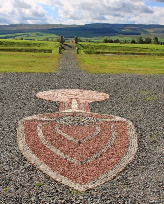 Solar flare mosaic, Crawick Multiverse
Within the Sun Amphitheatre at Crawick is this mosaic depiction of how the Earth is protected from Solar flares by its Magnet Field.  The sun is the furthest circle and the earth is the small circle of stones.  The interaction of Solar flares with Earths Magnetic field can be seen in the Aurora in the northern skies, sometimes visible as far south as north parts of the British Isles in areas with dark skies.
