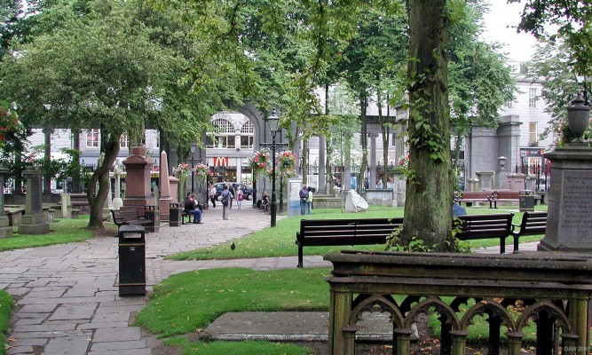 St Nicholas Kirkyard, Union Street, Aberdeen
St Nicholas Kirk lies on Union Street, Aberdeen's main shopping area.  Rather bizarrely, the graveyard is furnished with seats for weary shoppers and office workers to sit and eat their lunch.  I'm sure there?s something deeply ironic about customers from McDonalds across the road eating their allegedly nutritious meals in a graveyard.
