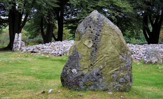 Standing Stone, Clava ring Cairn
Unlike the other Bronze Age cairns at Clava this one was never enclosed.  It may have been used as a tomb or maybe marked the position of a pyre to acompany ceremonies associated with the passage graves.  The surounding stone circle was added later with the highest stones on the side of the midwinter sun. [url=http://www.streetmap.co.uk/map.srf?X=275733&Y=844420&A=Y&Z=115/] Map location. [/url]
