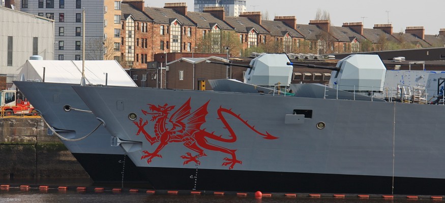 Take a Bow, Scotstoun
HMS Dragon and Defender at BAE yard in Scotstoun.  Apparently the Dragon was an unrequested addition put on by the shipyard during construction.  On arrival at her home port in Portsmouth the Royal Navy removed it citing the cost of maintaining it over the life of the warship as too high.
