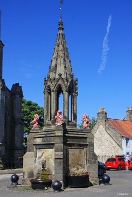 The Bruce Fountain, Falkland
In 1970 Falkland was made Scotland's first conservation village which means today it retains a quaint old look.  The Bruce Fountain was donated to the village by Tyndall Bruce in 1856 and in 1865 the lions were added. Two of these hold the Tyndall-Bruce Arms, while the other two hold the symbol of the Royal Burgh of Falkland.
