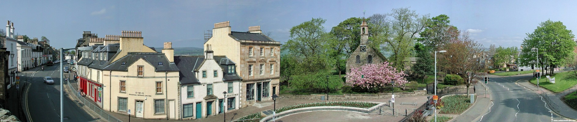 The Cross, Beith
The village of Beith grew from around this point.  The building behind the cherry blossom is the gable end of the old parochial church which was built on the site of a chapel run by Monks from Irvine.  There are stones with dates of 1593 on this building that probably date from the Chapel.  [url=http://www.streetmap.co.uk/map.srf?X=234885&Y=653945&A=Y&Z=120/] Map location. [/url]
