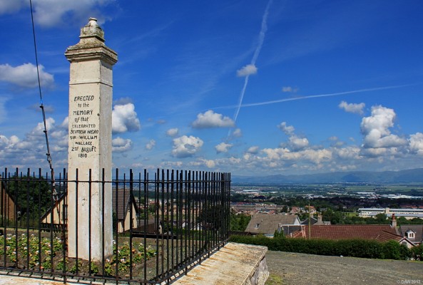 The Wallace Stone, at Wallacestone
Allegedly the location where William Wallace stood and watched the invading English Army led by Edward I in 1298.  On this occasion the Scots were defeated although the exact location of the battle seems to still be open for debate.  This stone replaced a much older earlier one.  Notice the appropriate saltire flag in the sky. [url=http://www.streetmap.co.uk/map.srf?X=291842&Y=677077&A=Y&Z=115/] Map location. [/url]
