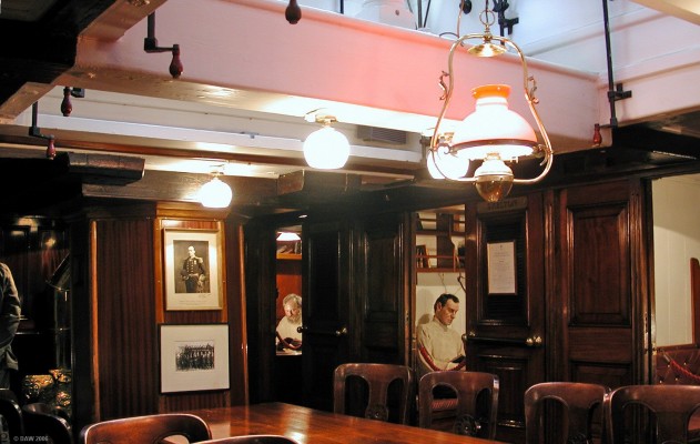 The Ward Room, RRS Discovery
This photograph doesn't really do justice to the impressive mahogany paneled Officers Ward room on board the Royal Researdch Ship Discovery.  Each of the 10 officers had a small berth on either side of the table.  A photo of Robert Scott, leader of the National Antarctic expedition of 1901, can be seen on the wall.
