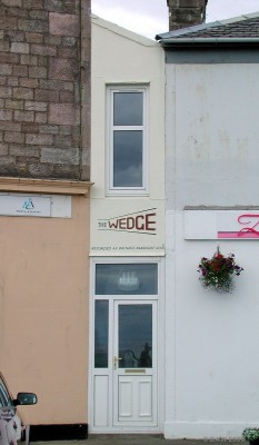 The Wedge, Millport
On the seafront at Millport lies this house, wedged into the narrow space between two other buildings, reportedly the smallest house in the UK.  If you have a cat and you like to swing it, this wouldn't be the house to buy.
