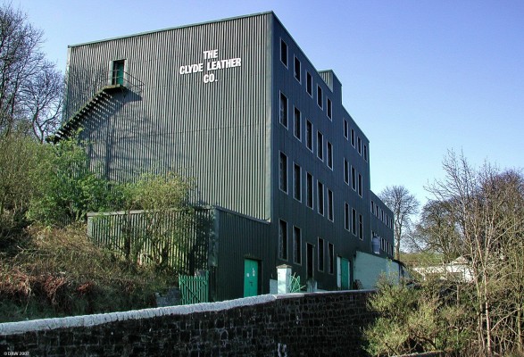 The former Broadlie Mill, Neilston
Underneath the unatractive modern cladding of the Clyde Leather Works is the old Broadlie Mill built around 1792 Mr Airston of Nether Kirkton.  By 1854 is had become a flax mill and then later still a dye works.  The Levern water flows past the Mill below the old stone wall you see in the photo.  [url=http://www.streetmap.co.uk/streetmap.dll?G2M?X=247500&Y=656500&A=Y&Z=3/]Map location[/url]
