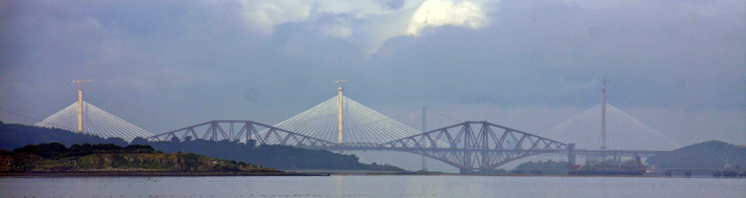 The Three Bridges, River Forth
A distant view from Leith Docks of the three Bridges over the River Forth.  Taken in 2016 when the newest of those bridges, the Queensferry Crossing, was still under construction.  Cramond Island is on the left.  [url=http://streetmap.co.uk/map.srf?X=326070&Y=677936&A=Y&Z=120/] Map location. [/url]

