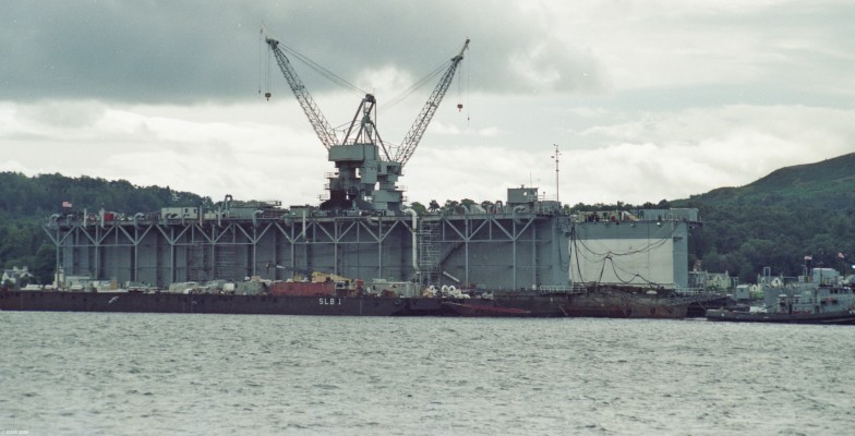 USS Los Alamos (ADB-7), Holy Loch
Pictured in the late 1980's in Holy Loch, the floating dock was part of the permanent presence the US Navy had there from 1964 until 1992 in support of the US Polaris Missile Submarines. The dock was built in 1944 and consisted of 7 seperate modules. In 1961 4 sections were brought to Scotland. The dock was capable of lifting a Polaris Submarine completely out the water for maintenance. 
