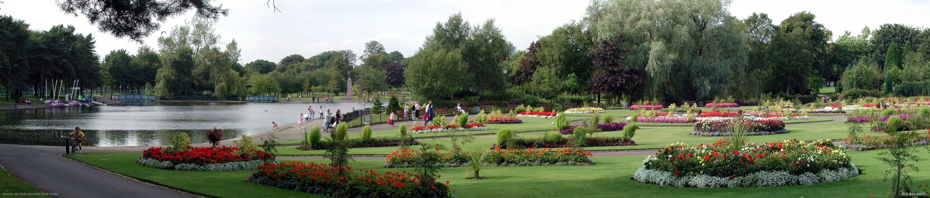 A summers day at Victoria Park, Glasgow
A view of the pond and summer bedding area.  The war memorial can be seen in the background on the right hand side of the pond.
