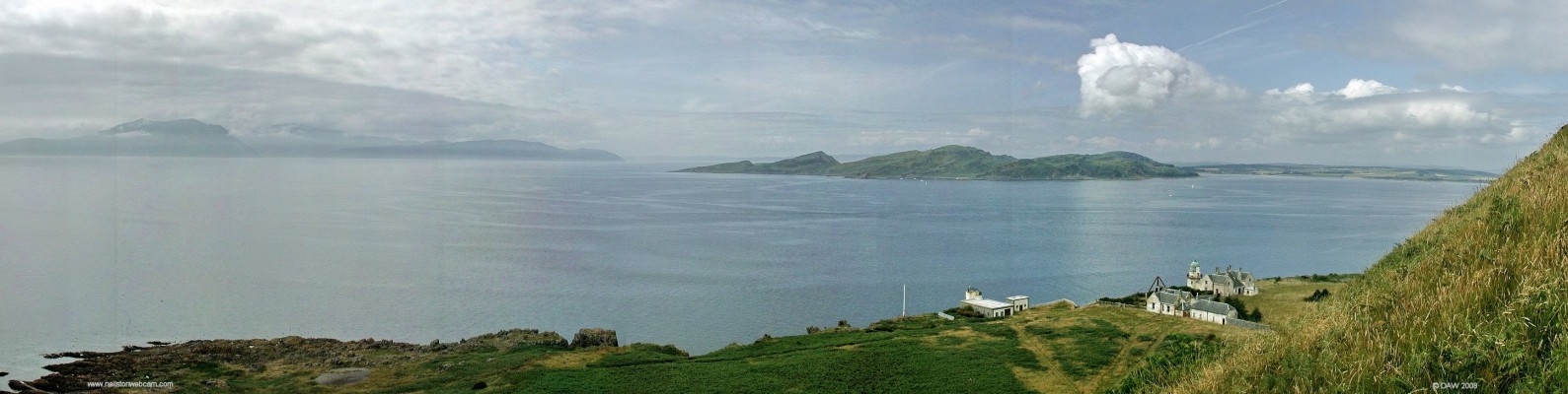 Looking out from the western side of the Wee Cumbrae
On the right is the lighthouse built in 1793, now disused.  To the left of that is what was presumably the compressor building for the foghorn, this is the present day automatic lighthouse with a rather unimpressive small beacon on top of a pole.  On the horizon on the left is the Island of Arran shrouded in mist, on the right is the tail end of the Island of Bute.  [url=http://www.streetmap.co.uk/streetmap.dll?G2M?X=213985&Y=651280&A=Y&Z=3/]Map location.[/url]
