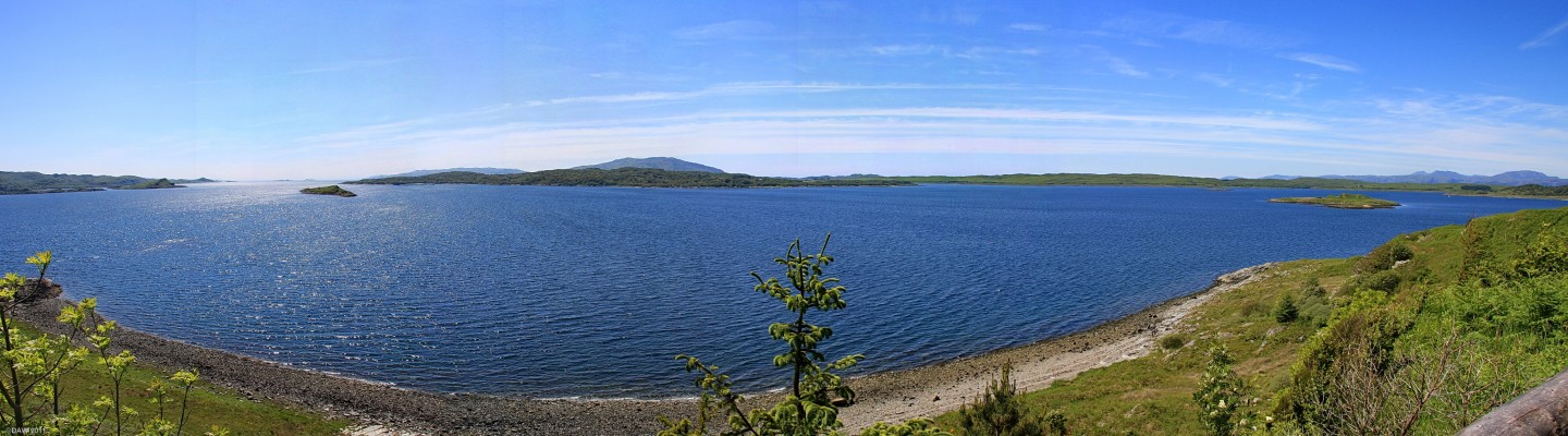 Panoramic view from Arduaine Gardens
In the foreground are the small Islands of Shuna and Luing.  In the centre is Cruach Scarba rising to 449 metres on the Island of Scarba.  To the left of this are the more distant and much higher Paps of Jura.  Onn the extreme right are the mountains of the Island of Mull. [url=http://www.streetmap.co.uk/map.srf?X=179120&Y=710480&A=Y&Z=130/] Map location. [/url]
