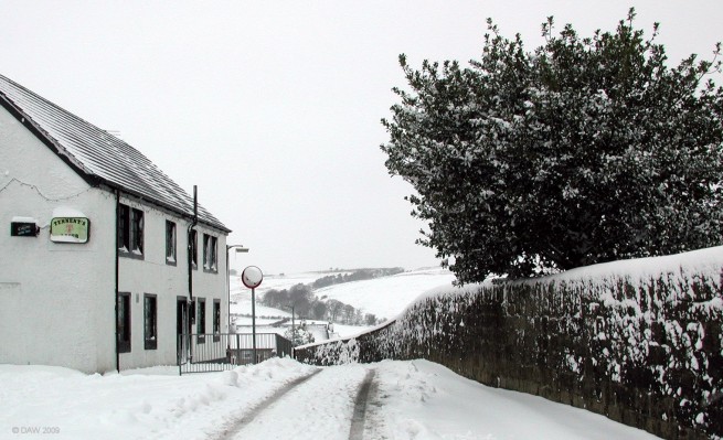 Broadlie Road, Neilston
Looking down Broadlie Road from the Main Street.  The Fereneze hills are in the distance.  Since this photo was taken in 2006 the Pub on the left has been demolished after a fire.

