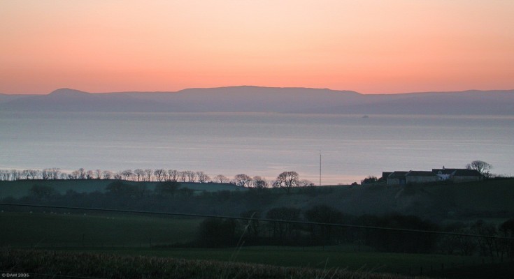 Arran view at dusk
Taken from the high road between West Kilbride and Ardrossan.  The bump on the left is the top of the Holy Isle.  The car ferry can be seen heading for Brodick on Arran.  [url=http://www.multimap.com/map/browse.cgi?lat=55.6668&lon=-4.8155&scale=25000&icon=x]Map location[/url]
