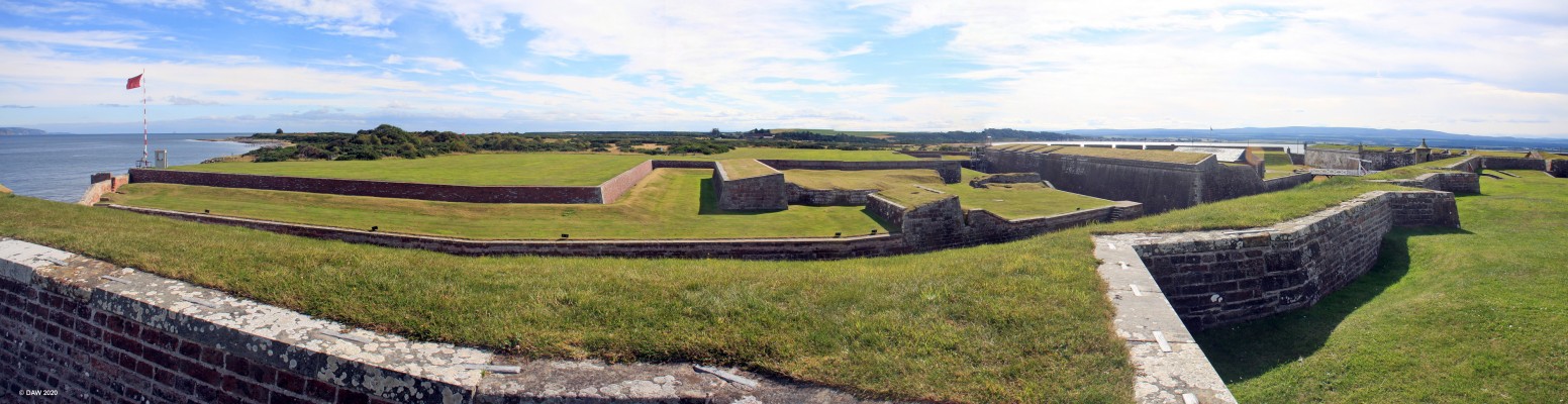 Fort George, forward defences
Looking out from the frontal ramparts of Fort George.  The grass behinds the walls is there to absorb artillery fire.  The Red flag flying on the left is because the present day garrison at the fort use the area beyond the fort as a live firing range.

