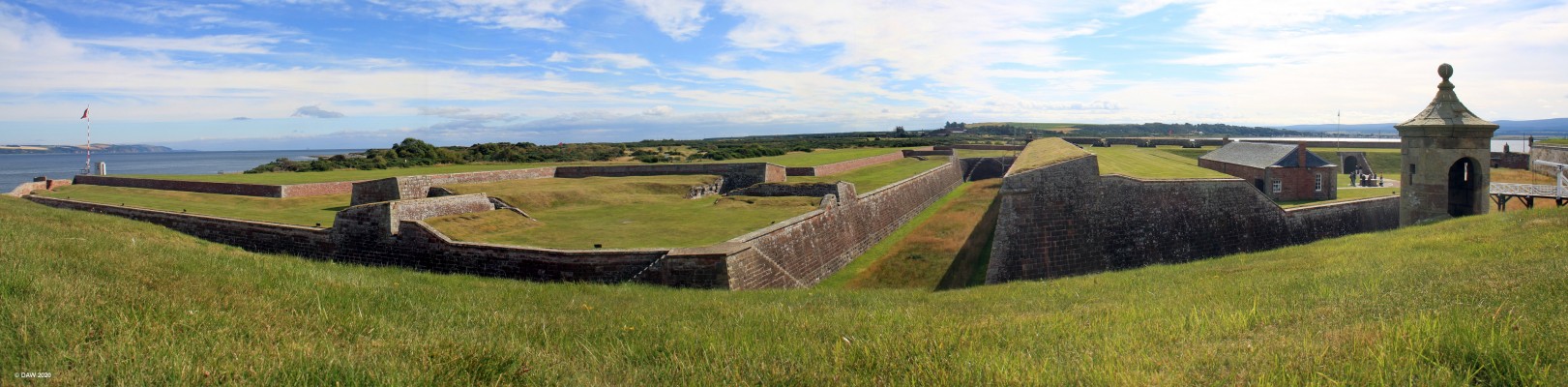 Forward defences, Fort George
Looking out from the main fort at the forward defences.  On the right is the principal bridge and Ravelin, a platform used for forward defence.  On the left firing positions can be seen for defenders.  The main ditch has steps to allow defenders to move from one location to another without being in the line of fire.
