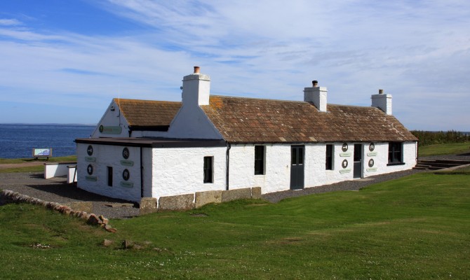 Allegedly the last house in Scotland
In reality its the last opportunity to sell tourists tartan dolls.  This is the original "last house" but there is now a new craft centre and car park for tour buses.  Also, John O'Groats is not the most northerly point on the mainland, that honour goes to Dunnet Head, but who am I to argue. [url=http://www.multimap.com/map/browse.cgi?lat=58.6436&lon=-3.0674&scale=25000&icon=x/]Map location[/url]
