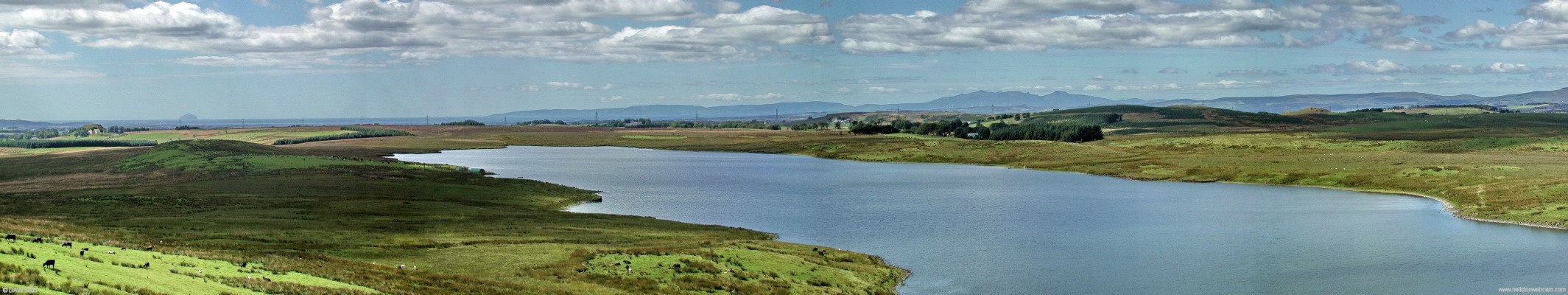 Long Loch West Panorama
Looking west over Long Loch from James's Hill.  The Island of Ailsa Craig over 60km away can be seen on the left on the horizon.  As you move right you see the hills of the Island of Arran, you can just make out the wind farm above ardrossan below the highest peaks.  The heads of Ayr are just visible on the extreme left.  [url=http://www.streetmap.co.uk/streetmap.dll?G2M?X=248590&Y=652890&A=Y&Z=3/] Map location. [/url]

