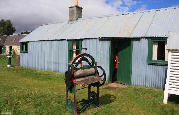 Steading cottage, Highland Folk Museum, Newtonmore
An example of a Steading cottage.  A small timber frame building covered with corrugated iron.  This one was built at the end of the 19th century and sits in its original location.  It would have housed farmer workers but also may have been used by the farmer's family in the summer to allow their own house (the stone building on the left) to be rented out as a holiday house.
