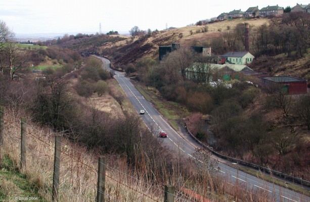 Broadlie Mill
The buildings in the trees make up what was Broadlie Mill, built in the 1790's.  It was originally a cotton spinning mill but later housed power looms.  This is the only former mill in Neilston that still has its Chimney (now unused) standing.  The factory is presently used by the Clyde Leather Company.

