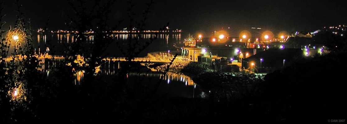 Over looking the BUTEC pier at Kyle of Lochalsh
This pier supports the British Underwater Test and Evaluation Centre which has a range near Applecross used to test Torpedoes and Sonar.  The lights of Kyleakin on the Isle of Skye can be seen reflected on the water in the distance.
[url=http://www.multimap.com/map/browse.cgi?lat=57.2803&lon=-5.7051&scale=10000&icon=x/]Map location[/url]
