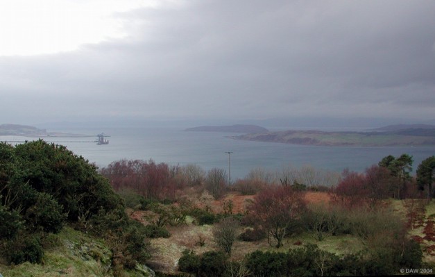Firth of Clyde view
Taken from the viewpoint above Largs on a dull winter day.   The first island on the right is the Great Cumbrae, behind that lies Bute, to the left is the Small Cumbrae and in the distance Arran just just about be seen.  On the extreme left is the Hunterston Penninsula with a ship docked at the Ore terminal, immediately behind the terminal can be seen the former Oil rig construction yard and the Power stations of Hunterston A and B on the penninsula

