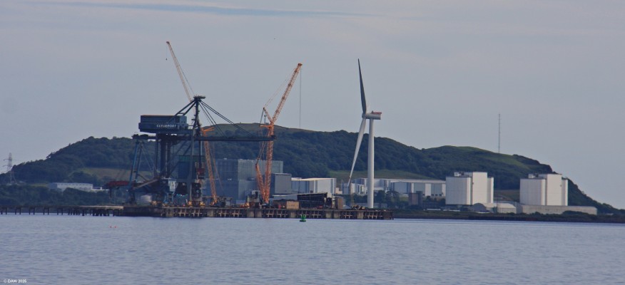 Hunterston as seen from Largs, 2019
A distant view of Hunterson from Largs.  The white buildings on the right are the former Hunterston A powerstation, the lower buildings to the left is the Invertor for the sub-sea interconnector to Wales and to the left of that is Hunterston B power station, now being decomissioned.  This photo also show the demise of Hunterston Ore terminal with the ore cranes in the process of being demolished.  [url=http://www.streetmap.co.uk/map?X=220211&Y=656773&A=Y&Z=120&ax=220686&ay=657648/] Map location. [/url]
