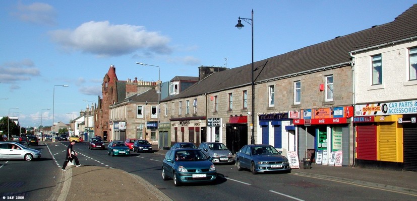 Barrhead Main Street
A sunny evening view along the main street.  This row of shops is one of the few parts of the main street that survived the onslaught of the dual carriageway but if you ignore the modern shop fronts the buildings are probably much as they were 100 years ago. [url=http://www.streetmap.co.uk/streetmap.dll?G2M?X=250125&Y=658870&A=Y&Z=120/]Map location.[/url]
