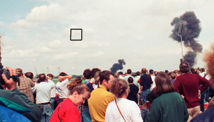 MIG 29 crash, Fairford 1993
On the 24th of July 1993 two Russian MIG-29 aircraft were doing an aerobatic display at the International Air Tatoo when they collided in mid-air during a cross over.  Both pilots ejected safely, one aircraft crashed within the air field and the other a mile or so away.  The black square in this photo shows one pilot on his parachute. Nobody on the ground was hurt.
