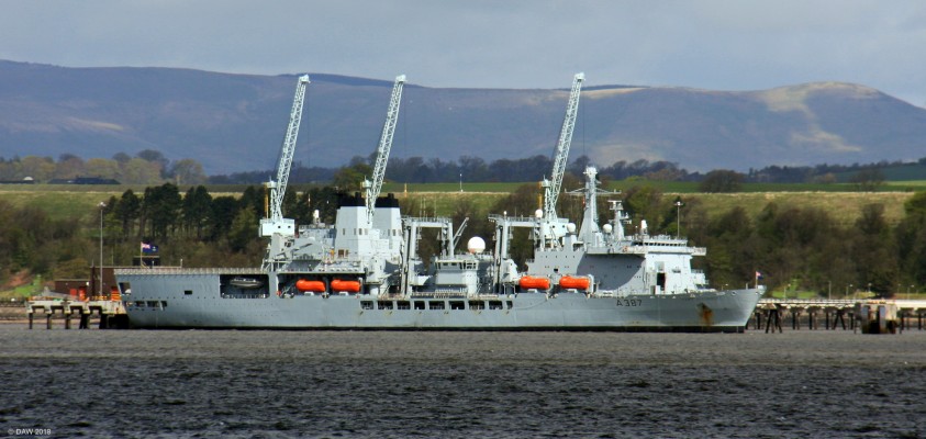 RFA Fort Victoria at DM Crombie as seen from Blackness, River Forth
DM Crombie was opened in 1916 to supply what was Rosyth Naval Dockyard a few miles down river.   RFA Victoria is combined fleet stores ship and was launched at Harland & Wolff in Belfast in 1990.  While she was still in dock being fitted out a bomb planeted by the IRA detonated in the engine room causing the ship to be holed and flooded.  The ship was only saved from sinking after a great effort by the emergency services and shipyard workers.  For this reason it was until 1994 that she entered service. 
