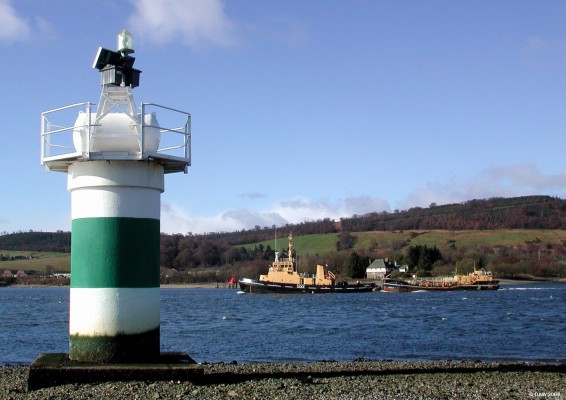 RMAS Nimble (A222), Rhu Narrows
All vessels entering and leaving Faslane Naval Base must pass through the Rhu Narrows, the distance between the green and red markers is less than 1km.  The tug boat Nimble is seen here towing a barge.  Nimble was commissioned in 1985 and displaces some 450 tons, her home port is Faslane. [url=http://www.multimap.com/map/browse.cgi?lat=56.0132&lon=-4.7917&scale=25000&icon=x]Map Location[/url]
