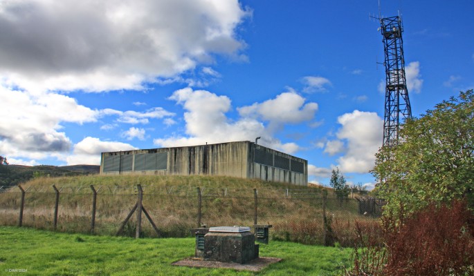 Cultybraggan ROC post and RGHQ bunker
Two relics of the cold war at Cultybraggan camp.  In the foreground is the hatch of an ROC post built in the 1960s and in the background the former Regional Government HQ bunker built in the late 1980s.  The concrete structure on top is part of the air filtration system.  Although completed the bunker was never used and now belongs to an Internet provider.  [url=http://streetmap.co.uk/map?X=276917&Y=720202&A=Y&Z=115/] Map location. [/url]
