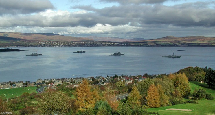 US Navy, Greenock
3 Arlreigh Burke and one Ticonderoga class warships of the US Navy visting the Clyde at Greenock in 2004.  During World War II this would have been a common sight as the Clyde was a reasonably safe anchorage for warships and convoys.  The area was protected by anti-aircraft guns at Inverkip and also a submarine net at the Cloch Lighthouse.

