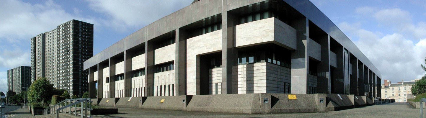 Glasgow Sheriff Court, Gorbals
Opened in 1986 to replace the original building on the north side of the river.  No expense was spared, it cost �30m at the time.  Stone was brought from as far as Norway.  The design is such that you might think they envisaged a complete breakdown of law and order in Glasgow, it has a deep moat all the way round.  The tower blocks at the rear are what replaced the 'slums' of the Gorbals in the 1960's.   At the time they were an improvement but today such dense housing is not being built in Glasgow. [url=http://www.streetmap.co.uk/streetmap.dll?G2M?X=259028&Y=664515&A=Y&Z=1/]Map location[/url]
