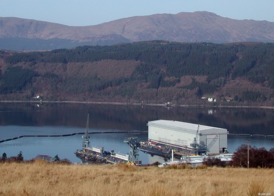 Over looking the Trident Jeti at Faslane, Gareloch
A seemingly picturesque view over the Trident Submarine Jeti at Faslane Naval Base on Gareloch.  But look closer at the top of hill on the opposite side of the loch and you see the watch towers in the Coulport Armaments depot.  The area on top of the hill is where Trident Missiles and warheads are stored if they are removed from one of the submarines for any reason. [url=http://www.streetmap.co.uk/map.srf?X=225596&Y=689492&A=Y&Z=115/] Map location. [/url]
