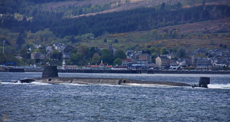 Vanguard Class Submarine, River Clyde
One of the Royal Navy's 4 Vanguard Class Submarines heads down the Clyde for a 6 week patrol.  Although they can carry up to 16 Trident D5 missiles they currently put to sea with 'only' 8 and up to 40 warheads.  The equivalent destructive power of about 400 Hiroshima weapons.   Dunoon Pier is in the background, note the armed fast launch at the rear trying to keep up, in total 4 boats, including a police launch, escort each Submarine out into the firth.
